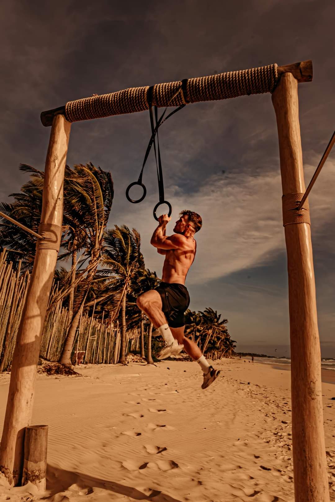 Mike Zdonczik training with gymnastics rings on the beach in Tulum